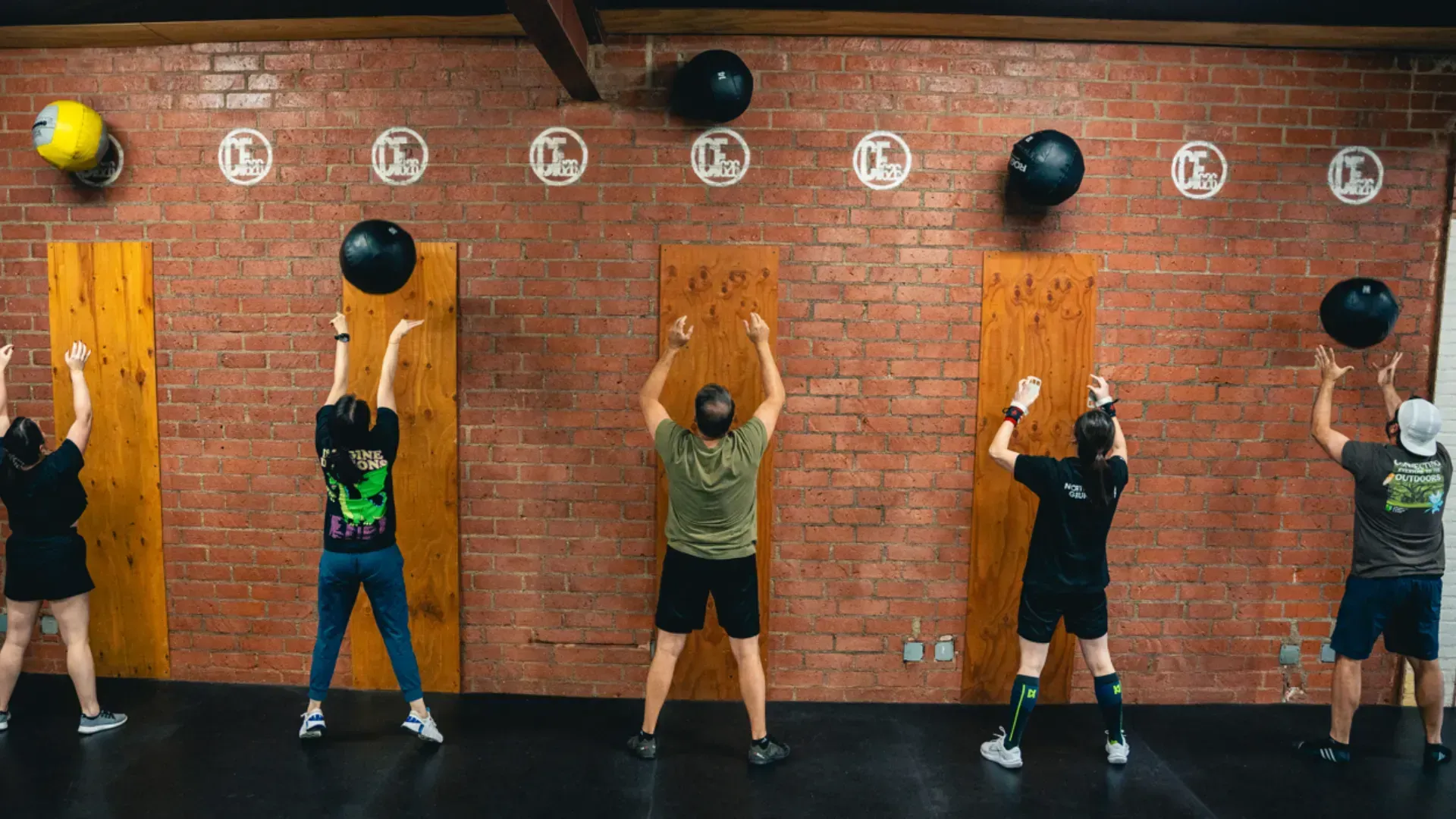 CrossFit 626 members performing wall-ball exercises during a group class